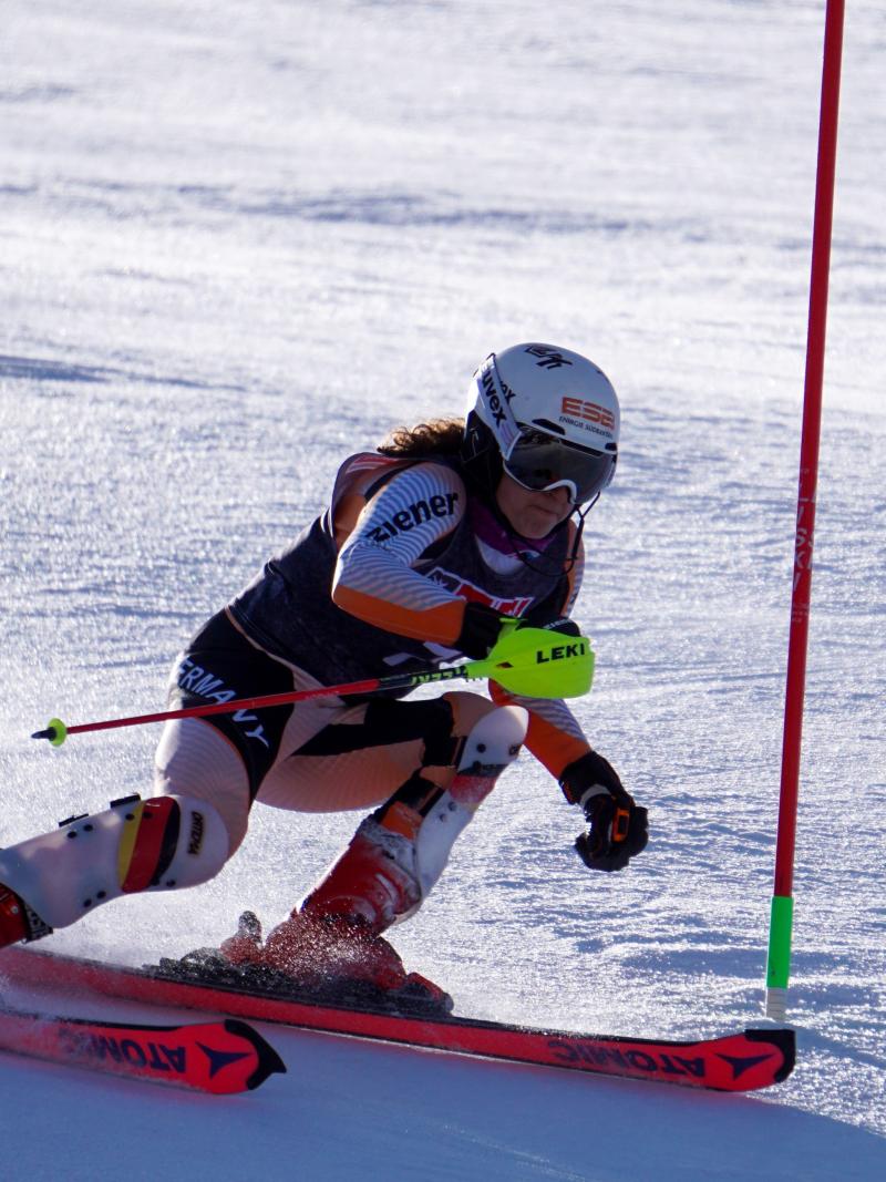 A woman competing in an alpine skiing slalom competition 